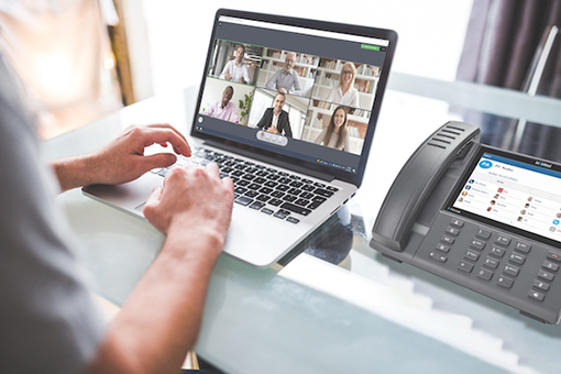 Tallahassee Man Attending Virtual Meeting Using Mitel Business Phone Systems