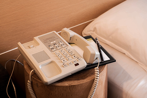 Phone Systems Unit On the Bedside Table of Tampa Hotel