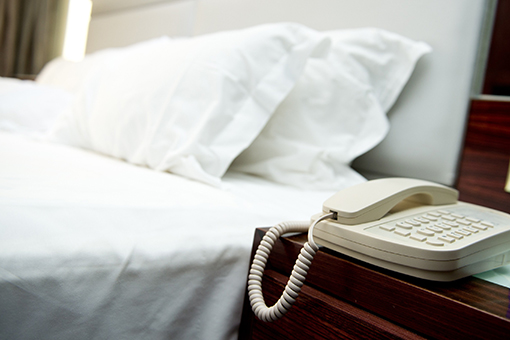 Bed, Pillows, and Phone System Unit at a Hotel in Kissimmee Florida