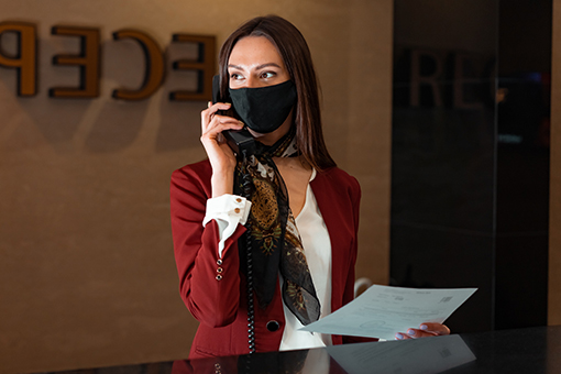 Gainesville Receptionist Receiving Room Service Call Using Their Hotel's New Phone Systems